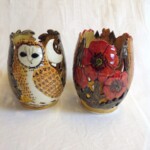 two clay pots with owl design and flower design